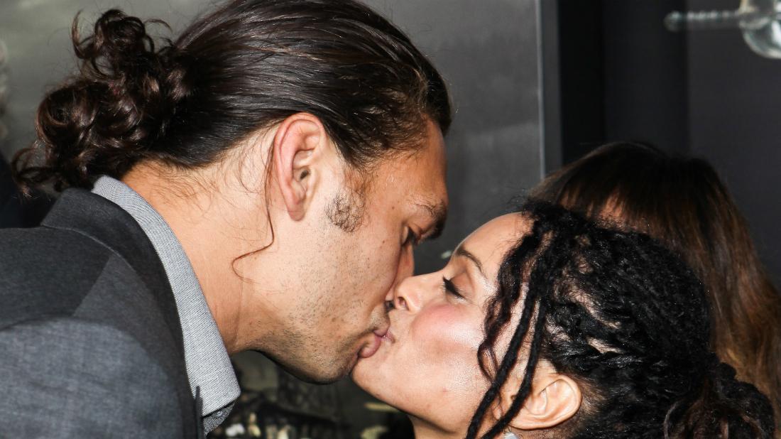 Lisa Bonet and James Momoa share a romantic moment on a red carpet premiere.